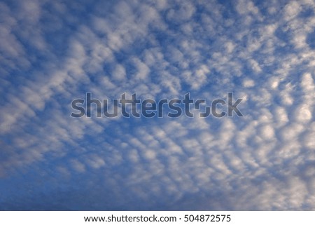 Artistic blue sky with white clouds at sunset