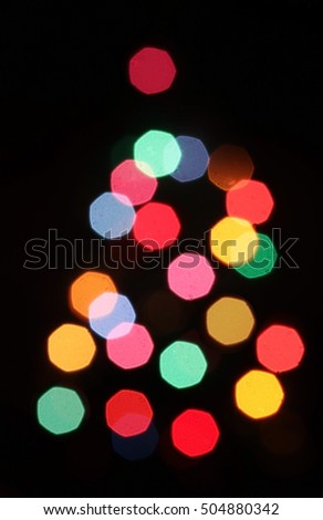 Christmas tree blurred lights silhouette on a black background