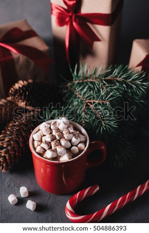 Hot chocolate or cocoa with marshmallows on gray background. Christmas presents. Holiday concept.