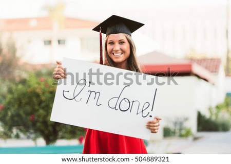Female graduate holding placard