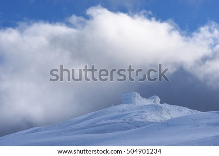 Winter landscape in the mountains. The old observatory on top. Beautiful texture of snow and neve. Carpathians, Ukraine, Europe