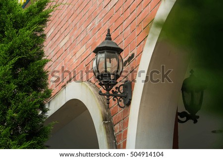 Outdoor Wall Lantern on yellow Brick Wall Background, Exterior