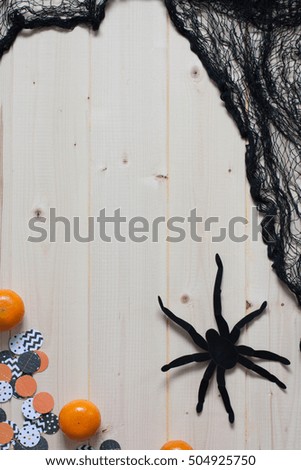 Halloween decoration  with a net, a spider, and clementines. Copy space. 