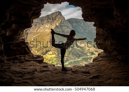 Girl being active on hike doing yoga in Wallys Cave, Cape Town South Africa Royalty-Free Stock Photo #504947068