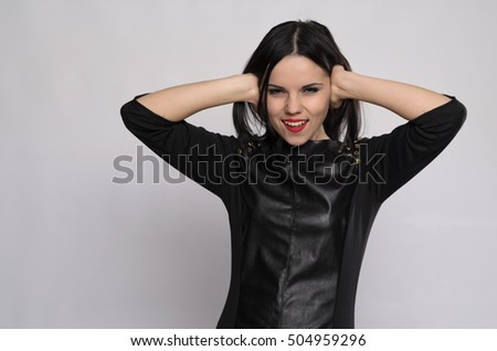Closeup portrait of a young woman suffering from a migraine headache on top of a loud noise coming from a neighbor, holding hands to ears covering to shut out noise, isolated on white background.