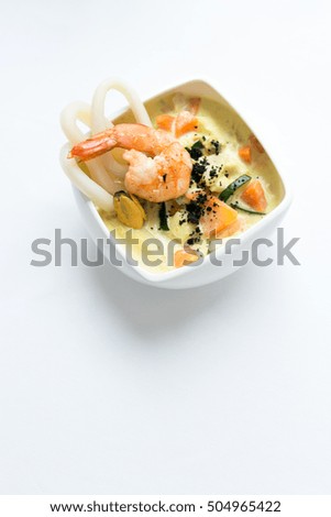 Seafood soup on a white surface