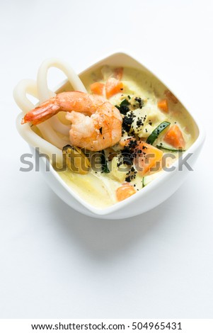 Seafood soup on a white surface