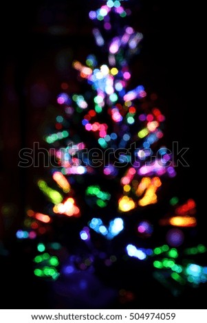Christmas tree blurred lights silhouette on a black background