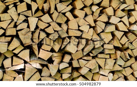 Pile of chopped fire wood logs prepared for winter. Close up, horizontal