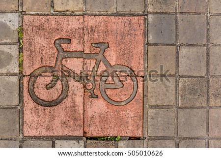 Bike road sign on pavement