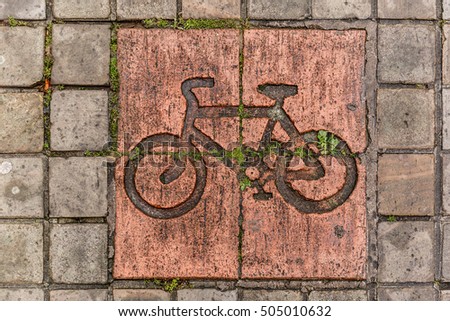 Bike road sign on pavement