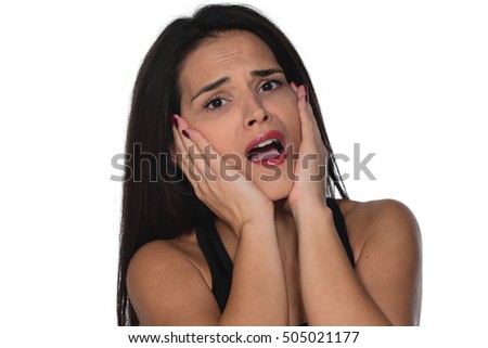 Picture of surprised beautiful young female holding her face isolated on white background