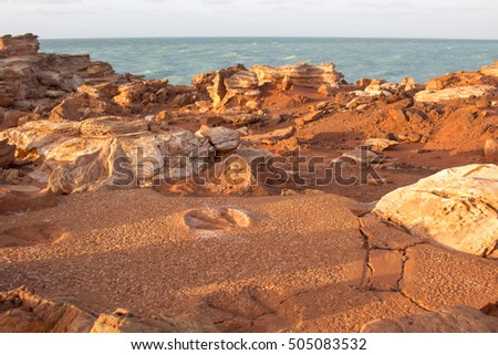 Ancient  Gantheaume Point,  a red-sandstone headland that juts out into the Indian Ocean from beautiful Cable Beach, Broome, North Western Australia is a popular tourist spot with dinosaur footprints.