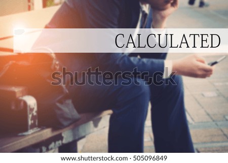 Hand writing CALCULATED with the abstract bokeh on background. This word represent the business as concept in stock photo.