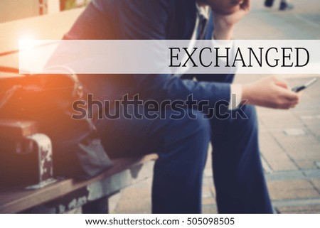 Hand writing EXCHANGED with the abstract bokeh on background. This word represent the business as concept in stock photo.