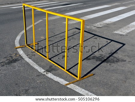 Yellow metal fence on zebra crossing. Abstract background.