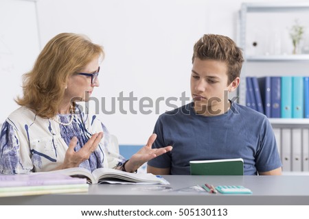 Teenage boy with learning problems having private lesson at home Royalty-Free Stock Photo #505130113