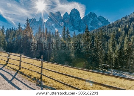 landscape with snow in the forest in the national park of the Dolomites in South Tyrol Italy Odle with sky and autumn colors in the forest roads and mountain streams