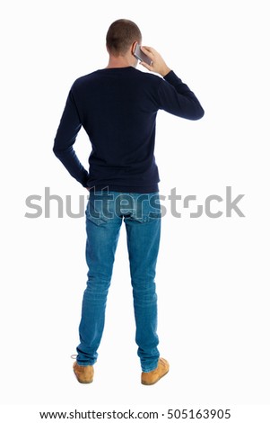 Back view of  pointing young men talking on cell phone. Young guy  gesture. Rear view people collection.  Isolated over white background. A guy in a black sweater talking on the phone