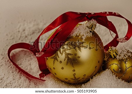 Gold Christmas decorations in white snow for a background HDR Filter.