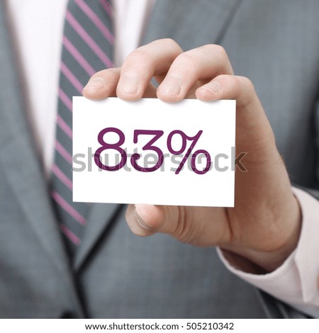 83% written on a card held by a businessman