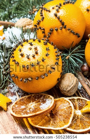 Christmas decorations and Christmas oranges on a wooden table and snow