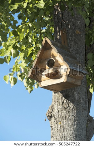 The nesting box hangs on a tree. The house waits for the inhabitant. Hope for new housing.