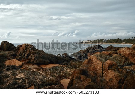 Large rocks on the background of the ocean with island