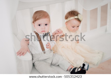 two babies - boy and girl dressed as bride and groom