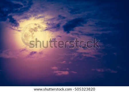 Background of nighttime sky with cloud and bright full moon with shiny. Natural beauty at night with beautiful full moon behind cloud. Vintage effect tone. 