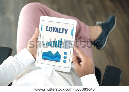 Business Charts Graphs on screen with LOYALTY Concept