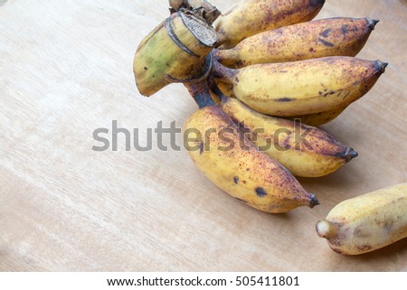 Fresh bananas on wooden background.
