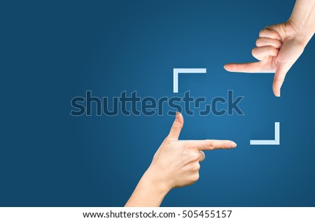 Female hands showing cropping composition gesture. Isolated on blue. Royalty-Free Stock Photo #505455157