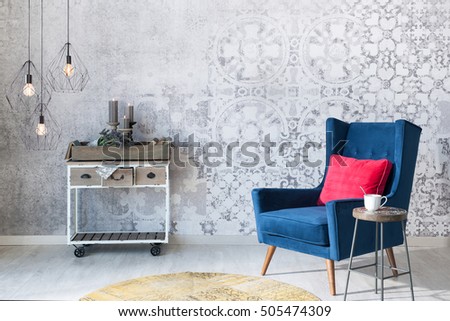 Beautiful grey wall with different home related objects, modern lamp