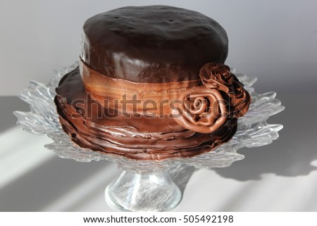 birthday cake decorated with modeling chocolate in shape of hat decorated with chocolate roses