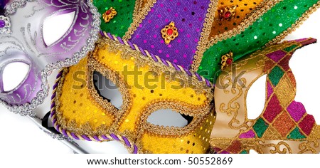 Assorted mardi gras masks including gold, purple and green on a white background