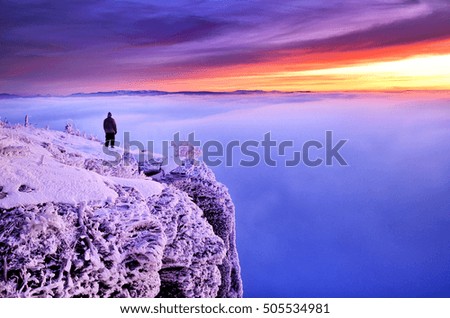 Man on the top of winter hill looking t the sunrise. Wallpaper with christmas theme