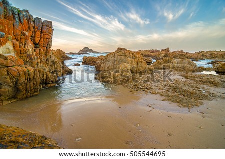Knysna heads sunset, rocks shore, Indian Ocean, Garden Route, South Africa Royalty-Free Stock Photo #505544695