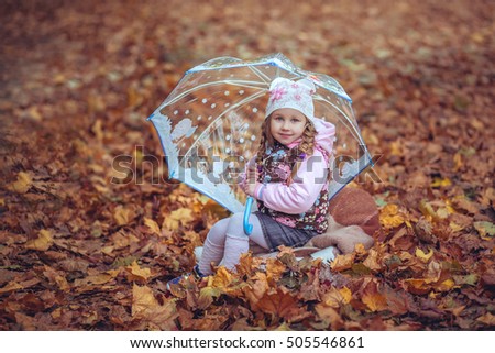 beautiful girl with umbrella in autumn