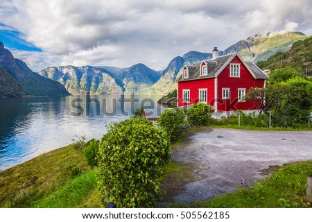 View to Sognefjord in Norway. Small town and cruise port Olden in Norwegian fjords.  Bird view of fjord in Norway.  under a sunny, blue sky, with the typical rorbu houses. View from the top Royalty-Free Stock Photo #505562185