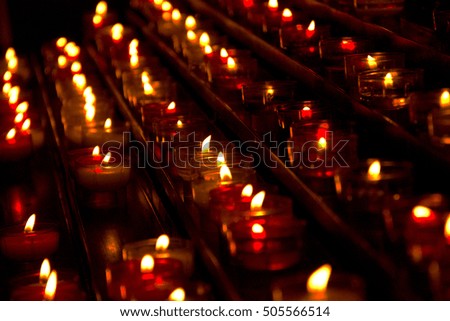 Hundreds of burning candles in a church