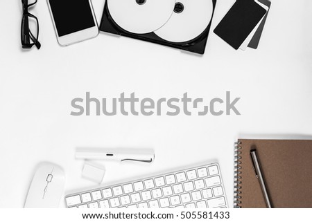 Top view Business desk Product introducing Top view, flat lay. notebook page, mobile smartphone, blank cover dvds, business objects on white table. Top view photography style.