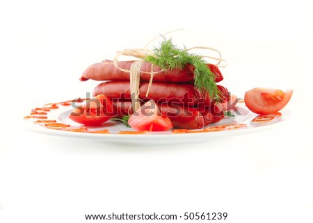 fresh pork smoked sausages on a white dish