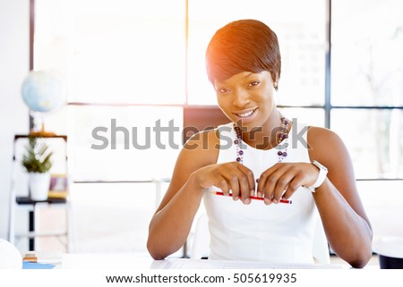 Young businesswoman sitting at desk and working