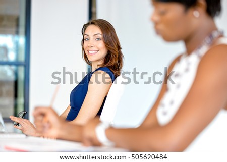 Young businesswoman sitting at desk and working