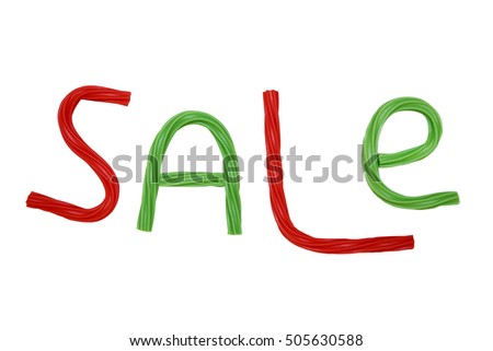 Christmas sale. inscription sale from the red and green twisted licorice candy. the concept of clearance sale in the traditional colors of  xmas. isolated on a white background