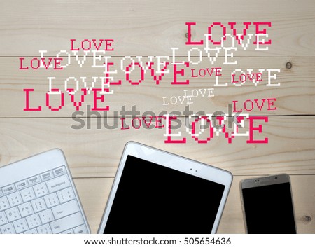 Smart phone and tablet,keyboard  with blank screen and hearts on old wooden table