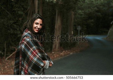young woman with blanket warm autumn in the forest