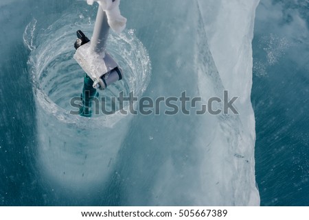 Ice-ax - ice screws on winter fishing. Royalty-Free Stock Photo #505667389