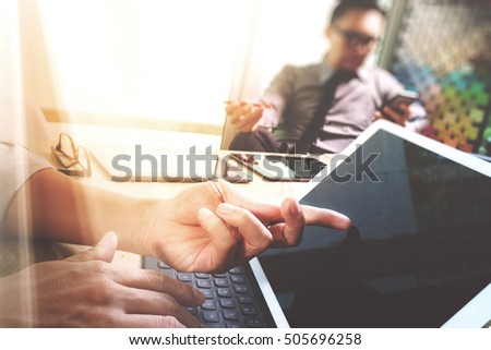Business team meeting present. Photo professional investor working with new start up project. Digital tablet laptop computer design smart phone using, keyboard docking screen foreground,sun flare